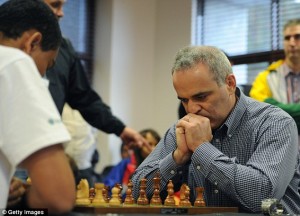 Moves: Kasparov plans his strategy as Marcil Roberts looks on during the match in Cape Town. Kasparov retired from professional chess in 2005 