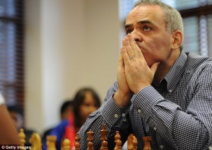 Intense: Kasparov clasps his hands to his face as he struggles over his next move at the charity exhibition game. The match was a little easier than the drawn out duels at the height of his fame